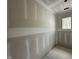 View of a room showcasing primed drywall and a window with natural light at 6505 Burnette Flower Way, Raleigh, NC 27612
