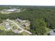 Wide aerial view of a community, showcasing the homes and surrounding lush greenery at 6521 Sunset Manor Dr, Wake Forest, NC 27587