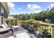 Inviting back deck with outdoor seating, plants, and a serene view of the backyard and trees at 6521 Sunset Manor Dr, Wake Forest, NC 27587