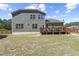 Expansive backyard showcasing a wooden deck perfect for outdoor entertaining and leisure activities at 6521 Sunset Manor Dr, Wake Forest, NC 27587