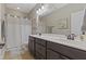 Bathroom featuring a double vanity with a granite countertop and modern fixtures at 6521 Sunset Manor Dr, Wake Forest, NC 27587