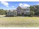 Stunning home with lush green lawn, stone facade, mature trees and attractive landscaping at 6521 Sunset Manor Dr, Wake Forest, NC 27587