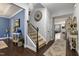 Spacious foyer with hardwood floors, staircase, and stylish decor at 6521 Sunset Manor Dr, Wake Forest, NC 27587
