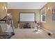 Large Home gym with projector screen for entertainment and a variety of equipment at 6521 Sunset Manor Dr, Wake Forest, NC 27587