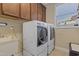 Bright laundry room featuring a washer, dryer, utility sink, and natural light from the window at 6521 Sunset Manor Dr, Wake Forest, NC 27587