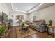 Cozy living room with a grey reclining sofa, area rug, and a tray ceiling at 6521 Sunset Manor Dr, Wake Forest, NC 27587