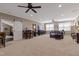 Spacious living room with carpet flooring, ceiling fan, sliding door, and breakfast bar at 6521 Sunset Manor Dr, Wake Forest, NC 27587