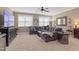 Spacious living room with large sectional sofa, TV, and carpet flooring at 6521 Sunset Manor Dr, Wake Forest, NC 27587