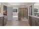 Bright main bathroom features a double vanity, separate tub, and glass shower at 6521 Sunset Manor Dr, Wake Forest, NC 27587