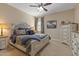 Bedroom featuring a queen bed, carpeted floor, ceiling fan, and artwork at 6521 Sunset Manor Dr, Wake Forest, NC 27587