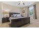 Bedroom featuring a ceiling fan, side tables, and queen bed with blue accents at 6521 Sunset Manor Dr, Wake Forest, NC 27587