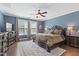 Spacious main bedroom boasts hardwood floors, natural light, and elegant furnishings at 6521 Sunset Manor Dr, Wake Forest, NC 27587