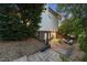 Brick patio with outdoor seating, landscaped areas, and a fenced perimeter in the backyard at 704 Walcott Way, Cary, NC 27519