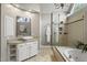 Modern bathroom features a glass enclosed shower, granite countertop vanity, and vessel sink at 704 Walcott Way, Cary, NC 27519