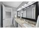 The bathroom features double sinks with granite countertops and a large mirror with modern lighting at 704 Walcott Way, Cary, NC 27519