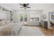 Bedroom featuring built-in shelving, ceiling fan, and access to the exterior at 704 Walcott Way, Cary, NC 27519