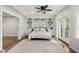 Finished bedroom with built-in shelving, ceiling fan, and access to the exterior at 704 Walcott Way, Cary, NC 27519