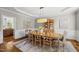 Elegant dining room with a stylish chandelier, classic wainscoting, and hardwood floors for sophisticated gatherings at 704 Walcott Way, Cary, NC 27519