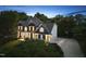 Lovely home featuring a manicured lawn, mature trees, and a basketball hoop on the driveway for outdoor fun at 704 Walcott Way, Cary, NC 27519