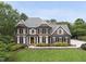 Well-maintained brick home with a lush green lawn, manicured bushes and a charming walkway to the front door at 704 Walcott Way, Cary, NC 27519