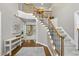 Spacious foyer featuring hardwood floors, elegant staircase with iron railings and an abundance of natural light at 704 Walcott Way, Cary, NC 27519