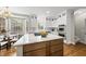 Bright kitchen featuring an island with wood cabinets, stainless steel appliances, and stylish lighting fixtures at 704 Walcott Way, Cary, NC 27519