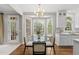 Bright kitchen featuring stainless appliances, marble countertops, and a breakfast area with bay windows at 704 Walcott Way, Cary, NC 27519