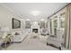 Bright living room with a fireplace, built-in bookshelves, and large windows overlooking the outdoor scenery at 704 Walcott Way, Cary, NC 27519