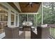 Inviting screened porch with ceiling fan and cozy furniture for relaxation and outdoor enjoyment at 704 Walcott Way, Cary, NC 27519
