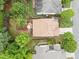 Aerial view of a landscaped yard with patio, mature trees, and a well-maintained roof at 7768 Berry Crest Ave, Raleigh, NC 27617