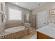 Bathroom featuring a soaking tub, glass enclosed shower, and tiled walls at 7768 Berry Crest Ave, Raleigh, NC 27617