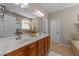 Bright bathroom featuring a double vanity, decorative flowers, and a large mirror at 7768 Berry Crest Ave, Raleigh, NC 27617