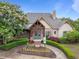 Charming clubhouse with stone accents, lush landscaping, and a welcoming entrance, perfect for community gatherings at 7768 Berry Crest Ave, Raleigh, NC 27617