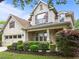 Charming two-story home with brick and siding, complemented by lush landscaping and a covered front porch at 7768 Berry Crest Ave, Raleigh, NC 27617