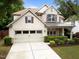 Lovely home featuring a spacious driveway, manicured lawn, charming front porch, and a two-car garage at 7768 Berry Crest Ave, Raleigh, NC 27617