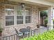 Cozy front porch with a small table and chairs, perfect for enjoying the outdoors and the view at 7768 Berry Crest Ave, Raleigh, NC 27617