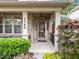 Inviting front porch with brick columns, decorative plants, and a welcoming entrance at 7768 Berry Crest Ave, Raleigh, NC 27617