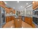 Open kitchen with granite countertops, a center island, stainless steel appliances, and adjacent dining area at 7768 Berry Crest Ave, Raleigh, NC 27617