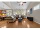 Bright living room with hardwood floors, neutral walls, and a ceiling fan, creating a comfortable and inviting space at 7768 Berry Crest Ave, Raleigh, NC 27617