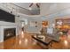 Spacious living room with a fireplace, hardwood floors, and an open view of the kitchen and upper level at 7768 Berry Crest Ave, Raleigh, NC 27617