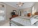 Comfortable main bedroom features a king bed, ceiling fan, and well-appointed dresser for storage at 7768 Berry Crest Ave, Raleigh, NC 27617