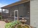 Screened porch with a decorative fountain and open views of the manicured backyard at 7768 Berry Crest Ave, Raleigh, NC 27617