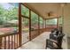 Screened porch with tiled floor, comfortable seating, and an open view of the backyard at 7768 Berry Crest Ave, Raleigh, NC 27617