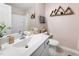 Stylish bathroom with a single sink vanity, mountain decor, and a shower-tub combo at 7807 Elmshire Way, Raleigh, NC 27616
