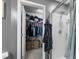 Bathroom view showcasing walk-in closet, walk-in shower with glass door and adjacent robe and towel hooks at 7807 Elmshire Way, Raleigh, NC 27616