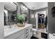 Bright bathroom featuring dual sinks, vanity with storage, and an adjacent closet for ample space at 7807 Elmshire Way, Raleigh, NC 27616
