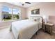 Inviting bedroom with cozy bed, stylish side table, a large window and views of a tree-lined street at 7807 Elmshire Way, Raleigh, NC 27616