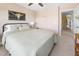 Comfortable bedroom with a queen bed, decor, a ceiling fan, and a view into the hallway at 7807 Elmshire Way, Raleigh, NC 27616