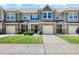 Beautiful townhomes showcasing stone accents, one-car garages, and charming front entrances with manicured lawns at 7807 Elmshire Way, Raleigh, NC 27616