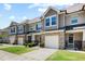 Charming townhomes with stone accents, one-car garages, inviting front entrances, and well-maintained lawns at 7807 Elmshire Way, Raleigh, NC 27616